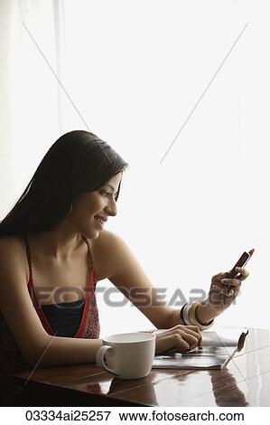 woman looking at text messages View Large Photo Image Stock Photo - woman looking at text messages. Fotosearch