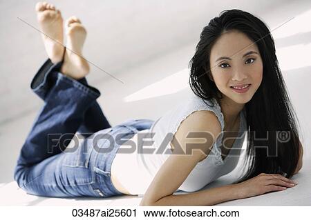 Woman lying on her stomach View Large Photo Image Stock Image - Woman lying on her stomach. Fotosearch