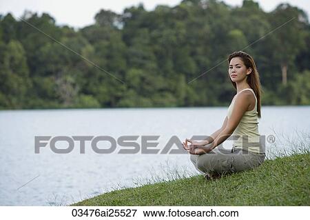 woman meditating by a lake View Large Photo Image Stock Photo - woman meditating by a lake. Fotosearch