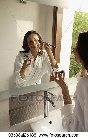 woman putting blush on cheeks View Large Photo Image Stock Photograph - woman putting blush on cheeks. Fotosearch