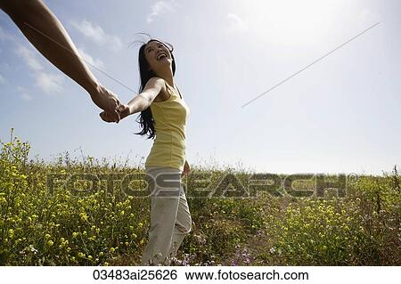 Woman walking holding man's hand View Large Photo Image Stock Photograph - Woman walking holding man's hand. Fotosearch
