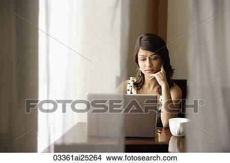 Picture - woman with laptop, cup of coffee. Fotosearch