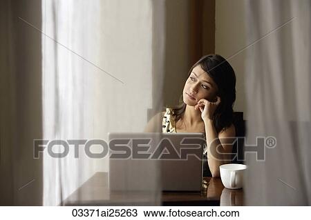 Stock Image - woman with laptop, cup of coffee. Fotosearch