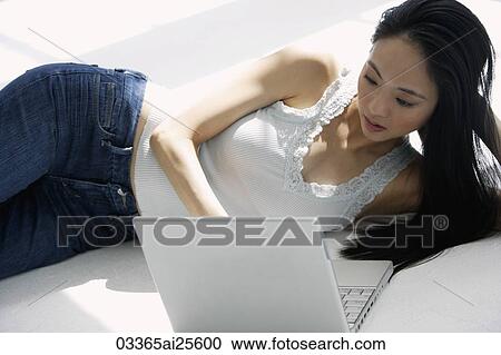 Woman working on laptop computer View Large Photo Image Stock Image - Woman working on laptop computer. Fotosearch