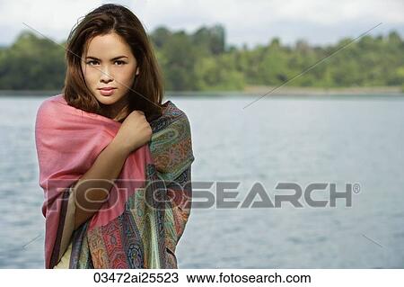 Woman wrapped in shawl, standing by lake View Large Photo Image Stock Image - Woman wrapped in shawl, standing by lake. Fotosearch