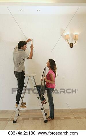 Stock Image - Young couple doing fix-it project. Fotosearch