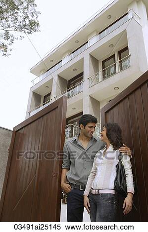 Young couple in front of home View Large Photo Image Stock Photography - Young couple in front of home. Fotosearch