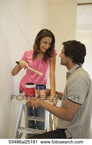 young couple painting home View Large Photo Image Stock Image - young couple painting home. Fotosearch