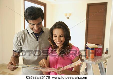 Young couple with paint supplies View Large Photo Image Stock Photograph - Young couple with paint supplies. Fotosearch