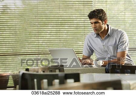 young man at laptop, with coffee View Large Photo Image Stock Photo - young man at laptop, with coffee. Fotosearch