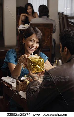 young man giving present to young woman View Large Photo Image Picture - young man giving present to young woman. Fotosearch