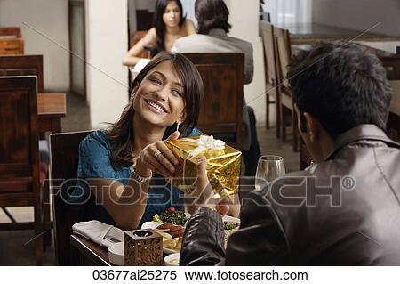 young man giving present to young woman View Large Photo Image Stock Photography - young man giving present to young woman. Fotosearch