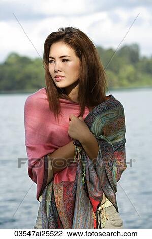 Young woman wrapped in shawl View Large Photo Image Stock Image - Young woman wrapped in shawl. Fotosearch