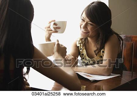 Stock Photo - young women enjoying coffee. Fotosearch