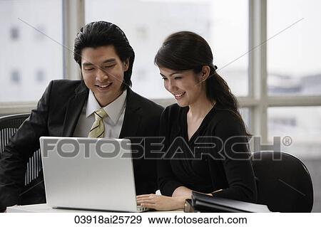Business colleagues working at computer View Large Photo Image Stock Photo - Business colleagues working at computer. Fotosearch