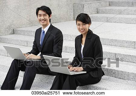 Business colleagues working on laptops View Large Photo Image Stock Image - Business colleagues working on laptops. Fotosearch