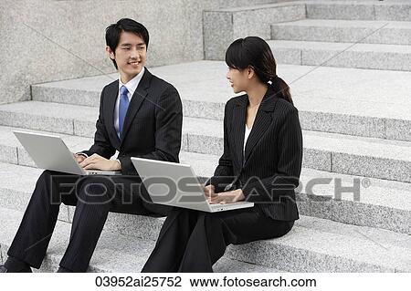 Stock Image - Business colleagues working on laptops. Fotosearch