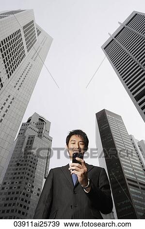 Stock Photo - Businessman reading messages. Fotosearch