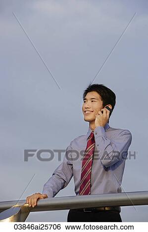 Businessman speaking on mobile phone View Large Photo Image Stock Photograph - Businessman speaking on mobile phone. Fotosearch