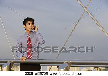 Stock Photography - Businessman speaking on mobile phone. Fotosearch