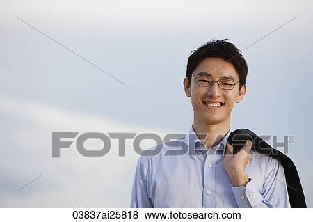 Businessman standing with jacket over shoulder View Large Photo Image Stock Photo - Businessman standing with jacket over shoulder. Fotosearch