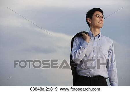 Businessman standing with jacket over shoulder View Large Photo Image Stock Photo - Businessman standing with jacket over shoulder. Fotosearch