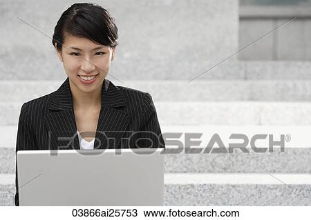 Stock Image - Businesswoman working on laptop. Fotosearch
