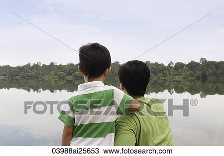 Father and son looking at lake View Large Photo Image Stock Image - Father and son looking at lake. Fotosearch