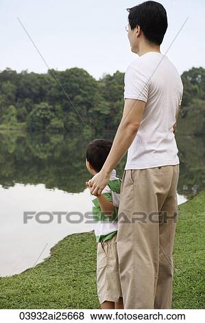 Father and son looking at lake View Large Photo Image Stock Photo - Father and son looking at lake. Fotosearch