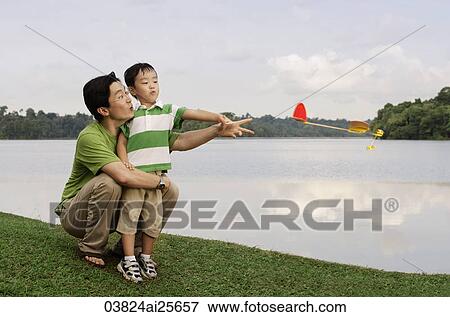Father and son playing with toy airplane View Large Photo Image Stock Photo - Father and son playing with toy airplane. Fotosearch