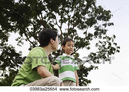 Father and sun under a tree View Large Photo Image Picture - Father and sun under a tree. Fotosearch