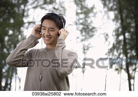 Man listening to head set View Large Photo Image Stock Image - Man listening to head set. Fotosearch