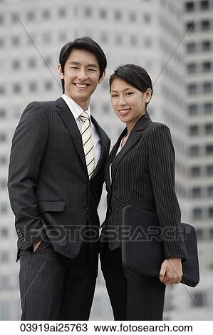 Stock Image - Portrait of business colleagues smiling. Fotosearch