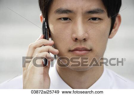 Stock Photo - Portrait of man on mobile phone. Fotosearch