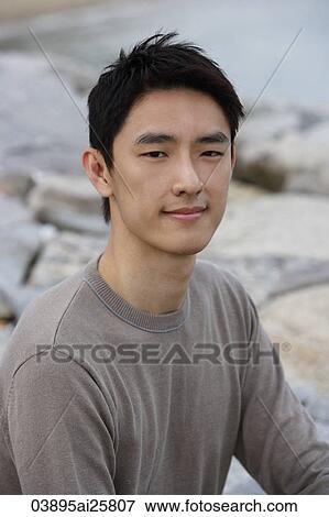 Portrait of man sitting on seashore View Large Photo Image Stock Photo - Portrait of man sitting on seashore. Fotosearch