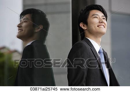 Profile and reflection of businessman smiling View Large Photo Image Stock Photography - Profile and reflection of businessman smiling. Fotosearch