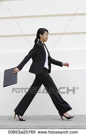 Profile of business woman walking View Large Photo Image Stock Photo - Profile of business woman walking. Fotosearch