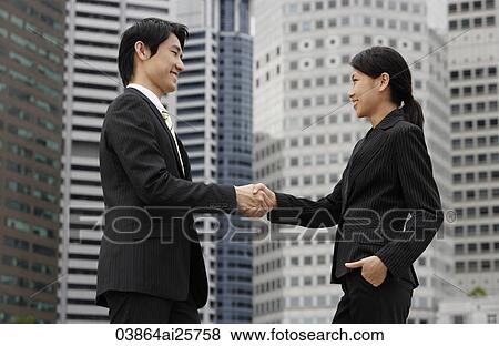 Profile of two business colleagues shaking hands View Large Photo Image Stock Photo - Profile of two business colleagues shaking hands. Fotosearch