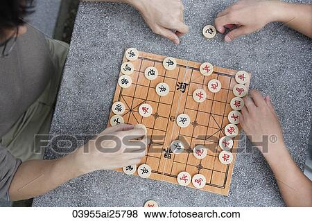 Stock Photo - Top view of men playing Chinese chess. Fotosearch