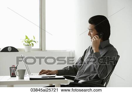 Young businessman at computer View Large Photo Image Stock Image - Young businessman at computer. Fotosearch