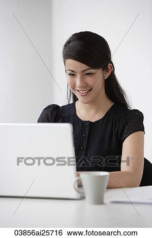 Young woman at computer View Large Photo Image Stock Photograph - Young woman at computer. Fotosearch