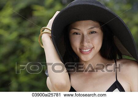 Young woman wearing big black hat View Large Photo Image Stock Image - Young woman wearing big black hat. Fotosearch