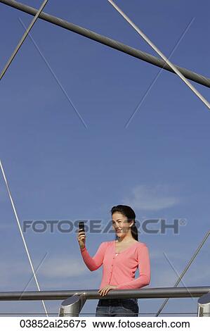 Young woman with cell phone View Large Photo Image Stock Photography - Young woman with cell phone. Fotosearch