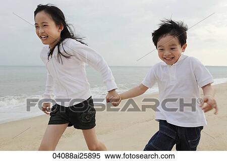 Boy and girl running on beach View Large Photo Image Stock Photography - Boy and girl running on beach. Fotosearch