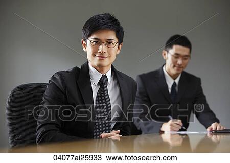 Stock Image - Businessmen in conference room. Fotosearch