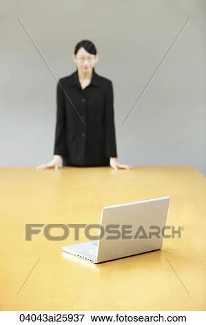 businesswoman staring at laptop on conference table View Large Photo Image Stock Photo - businesswoman staring at laptop on conference table. Fotosearch