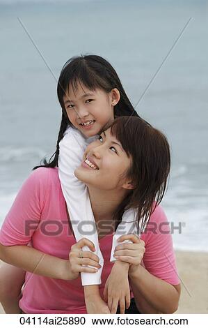 Stock Image - girl with arms around young woman. Fotosearch