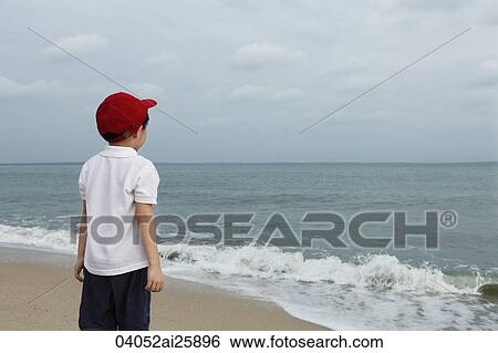 Little boy watching ocean View Large Photo Image Stock Photograph - Little boy watching ocean. Fotosearch