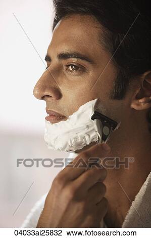 Stock Image - Man shaving his face. Fotosearch