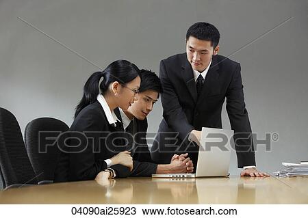 Three colleagues working in conference room View Large Photo Image Stock Image - Three colleagues working in conference room. Fotosearch